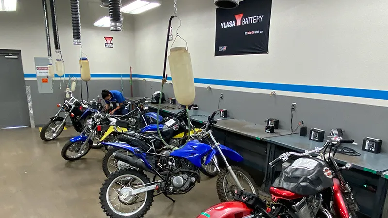 Yuasa branded lab with motorcycles at MMI