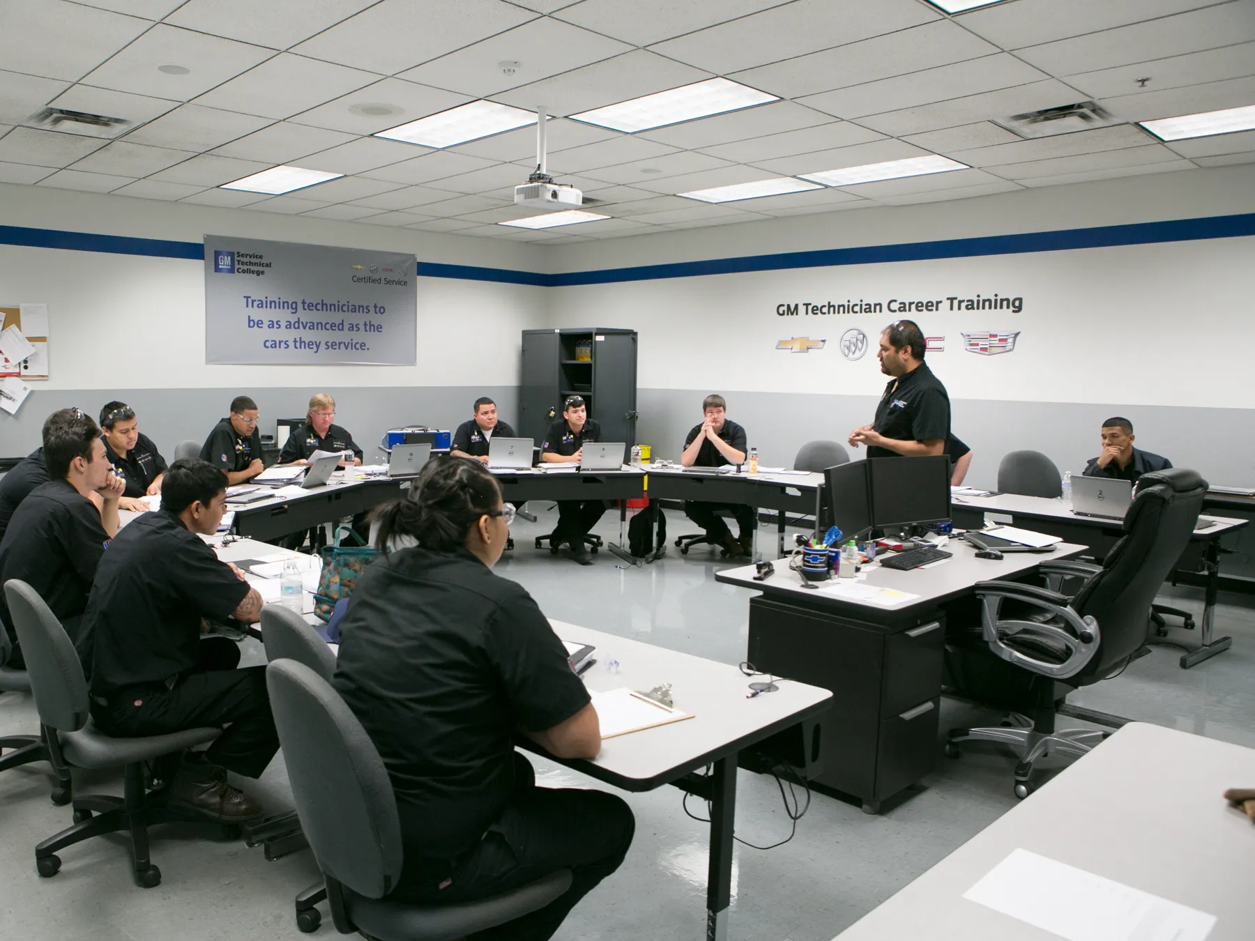 UTI students and Instructor in the GM classroom learning
